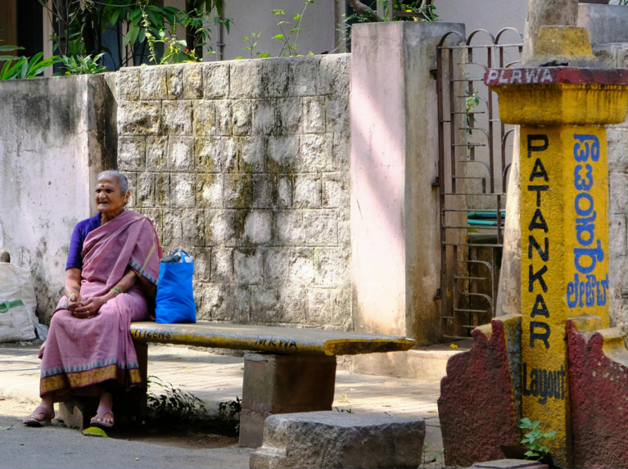 Women sitting in urban public space, representing safer cities and gender-responsive urban governance.