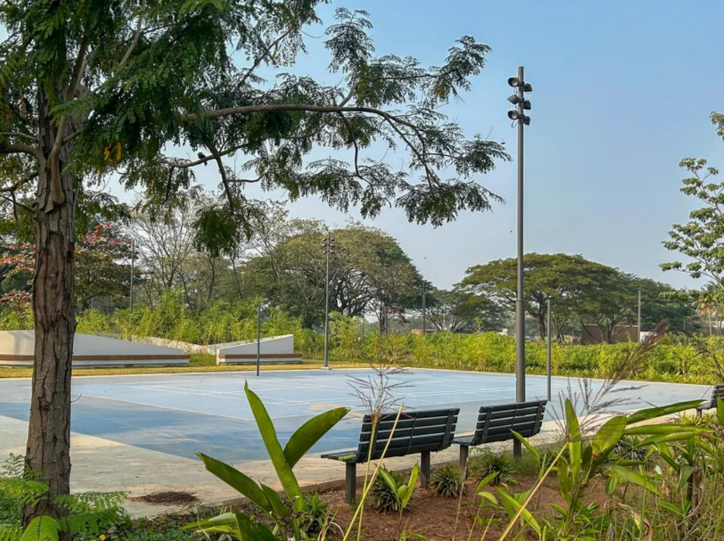 Outdoor play court and seating area surrounded by trees at Sponge park Chennai India.