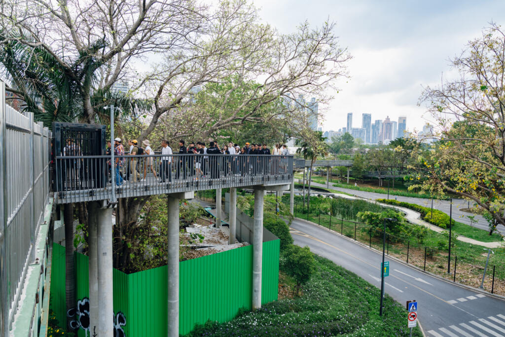 Elevated Green Bridge platform overlooking Benjakitti Park and Bangkok skyline